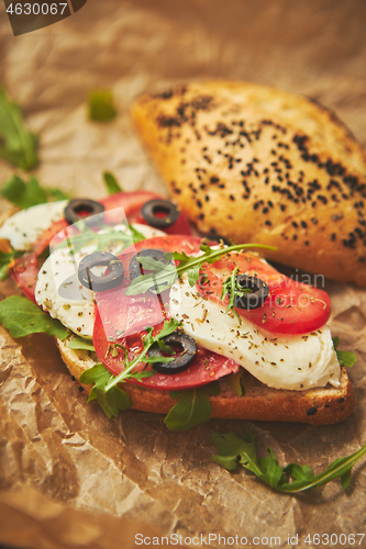 Image of Delicious fresh Bruschetta with tomato, basil, black olives and mozarella cheese