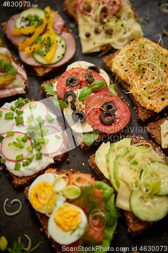 Image of Top view of different decorated sandwiches as appetizer. Healthy food. Vegetable meal