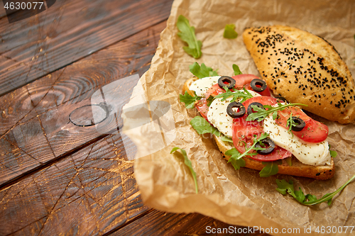 Image of Delicious fresh Bruschetta with tomato, basil, black olives and mozarella cheese