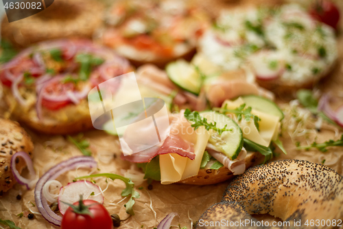 Image of Composition of various homemade bagels sandwiches with sesame and poppy seeds