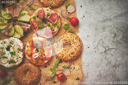 Image of Composition of various homemade bagels sandwiches with sesame and poppy seeds