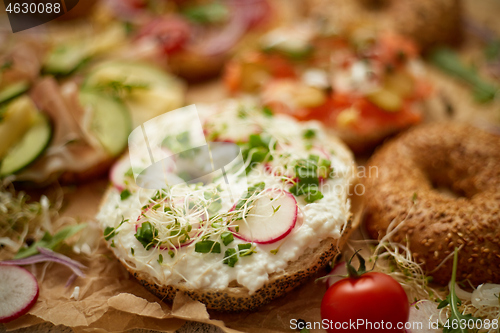 Image of Composition of various homemade bagels sandwiches with sesame and poppy seeds