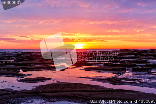 Image of Pretty sunrise over the ocean and beach