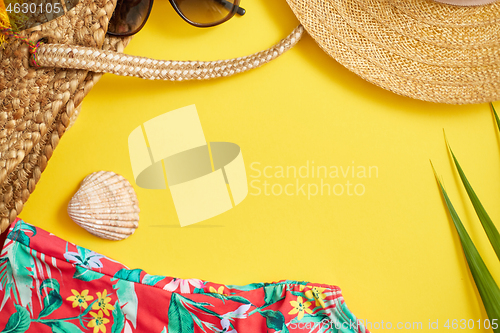 Image of Female beach summer clothes and accessories collage on yellow ba