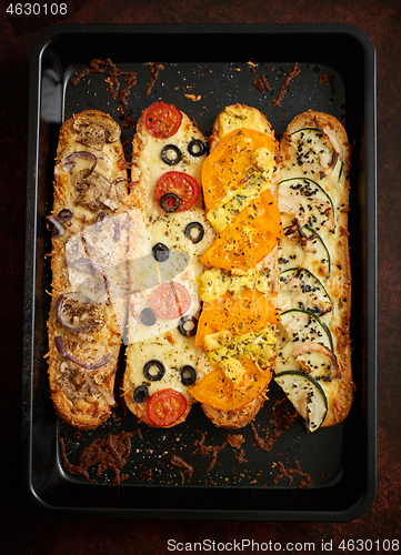 Image of Composition of hot tasty baked sandwiches with various toppings.