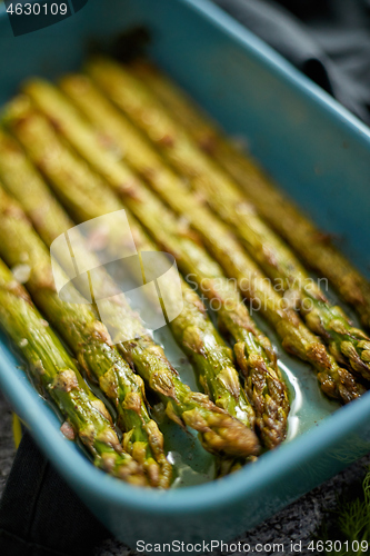 Image of Close up with selective focus on roasted asparagus seasoned with salt, pepper, garlic.