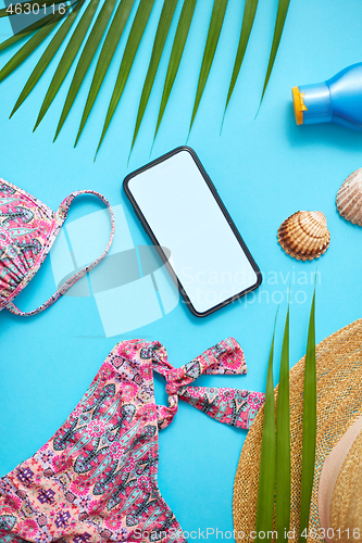 Image of Women beach summer clothes and accessories collage on blue backg