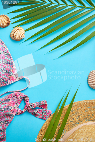 Image of Women beach summer clothes and accessories collage on blue backg