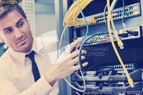 Image of young it engeneer in datacenter server room