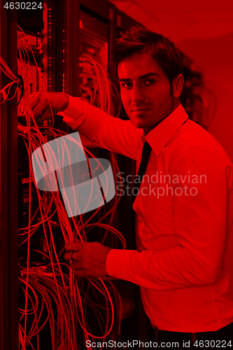 Image of young it engineer in datacenter server room