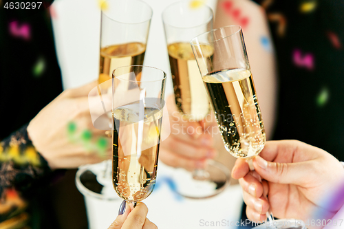 Image of Celebration. Hands holding the glasses of champagne and wine making a toast.