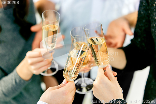 Image of Celebration. Hands holding the glasses of champagne and wine making a toast.