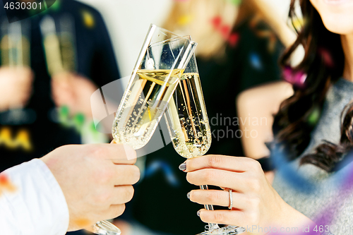 Image of Celebration. Hands holding the glasses of champagne and wine making a toast.