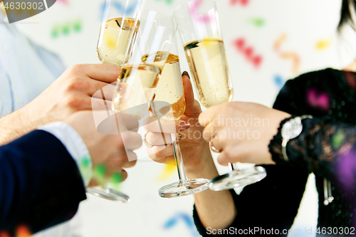 Image of Celebration. Hands holding the glasses of champagne and wine making a toast.