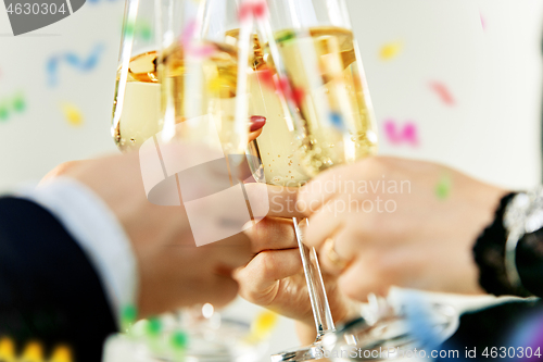 Image of Celebration. Hands holding the glasses of champagne and wine making a toast.