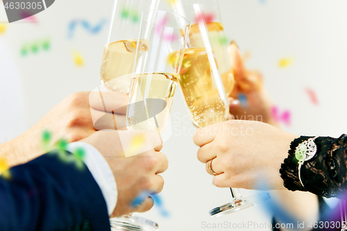 Image of Celebration. Hands holding the glasses of champagne and wine making a toast.