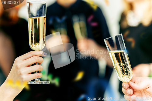 Image of Celebration. Hands holding the glasses of champagne and wine making a toast.