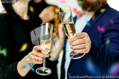 Image of Celebration. Hands holding the glasses of champagne and wine making a toast.