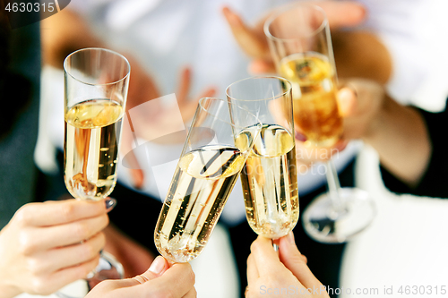 Image of Celebration. Hands holding the glasses of champagne and wine making a toast.