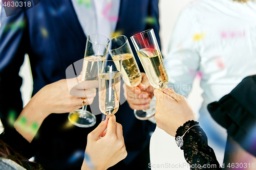 Image of Celebration. Hands holding the glasses of champagne and wine making a toast.