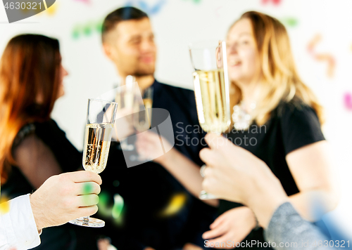 Image of Celebration. Hands holding the glasses of champagne and wine making a toast.