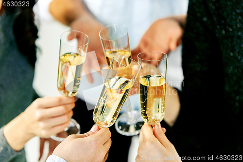 Image of Celebration. Hands holding the glasses of champagne and wine making a toast.