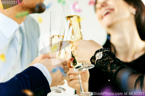 Image of Celebration. Hands holding the glasses of champagne and wine making a toast.