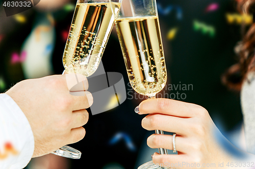 Image of Celebration. Hands holding the glasses of champagne and wine making a toast.