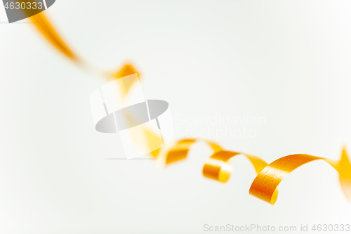 Image of golden confetti serpentine ribbon isolated on white