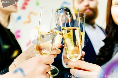 Image of Celebration. Hands holding the glasses of champagne and wine making a toast.