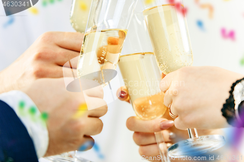 Image of Celebration. Hands holding the glasses of champagne and wine making a toast.