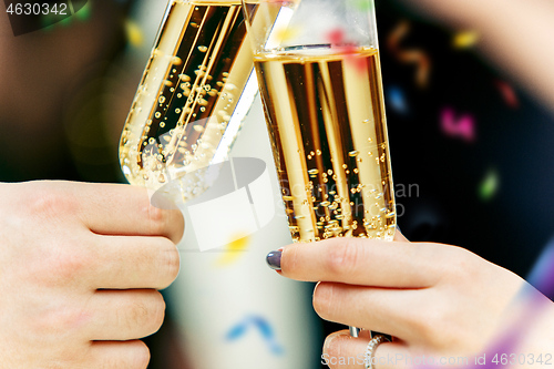 Image of Celebration. Hands holding the glasses of champagne and wine making a toast.