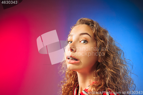 Image of Young woman with disgusted expression repulsing something