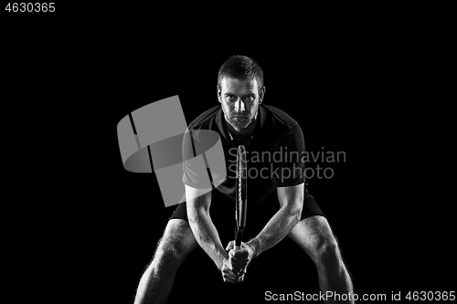 Image of one caucasian man playing tennis player on black background