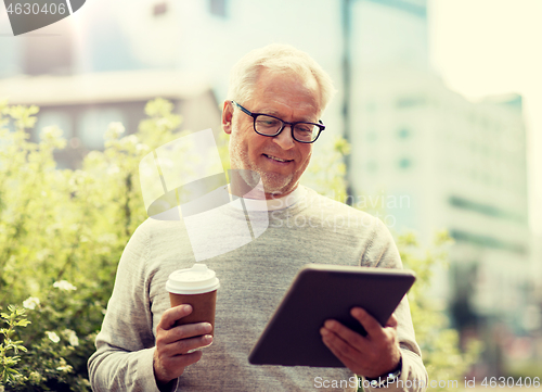 Image of senior man with tablet pc and coffee in city