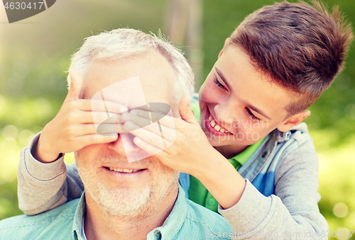 Image of grandfather and grandson playing at summer park