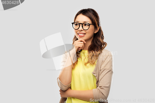 Image of happy asian woman in glasses or student