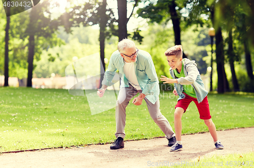 Image of grandfather and grandson racing at summer park