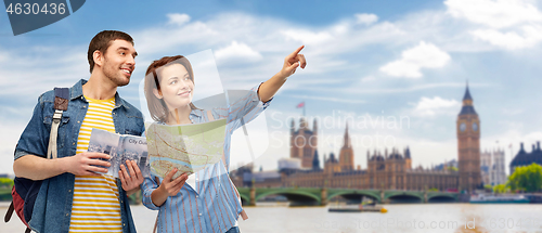 Image of happy couple of tourists with city guide and map