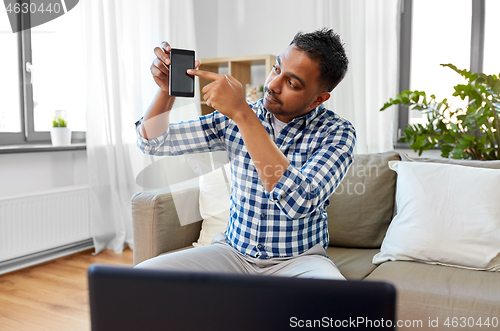 Image of male blogger with smartphone videoblogging