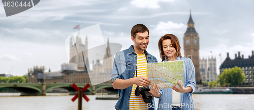 Image of couple of tourists with map and camera in london