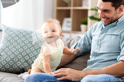 Image of father with little baby daughter at home