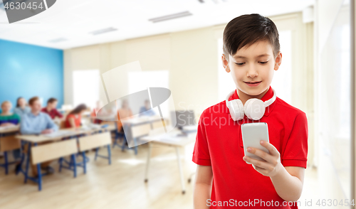 Image of boy in red t-shirt with headphones and smartphone