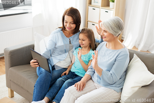 Image of mother, daughter and grandmother with tablet pc