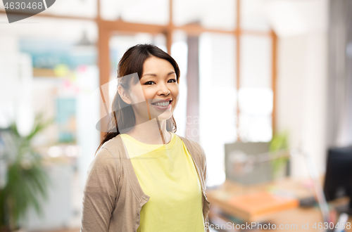 Image of happy asian woman over office background