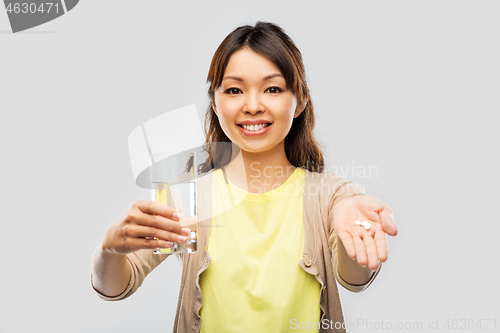 Image of happy asian woman over grey background