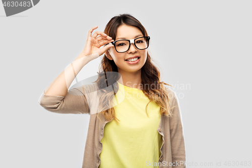 Image of happy asian woman in glasses or student