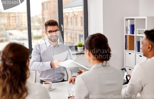 Image of male employee having job interview with recruiters