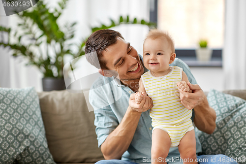 Image of father with little baby daughter at home