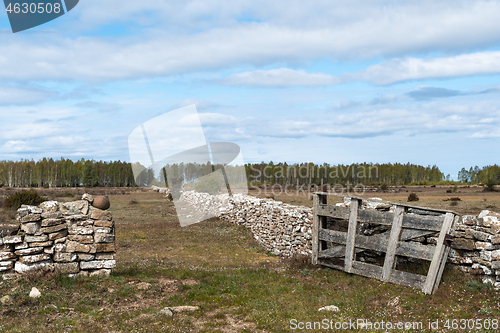 Image of Old wooden gate by a dry stone wall